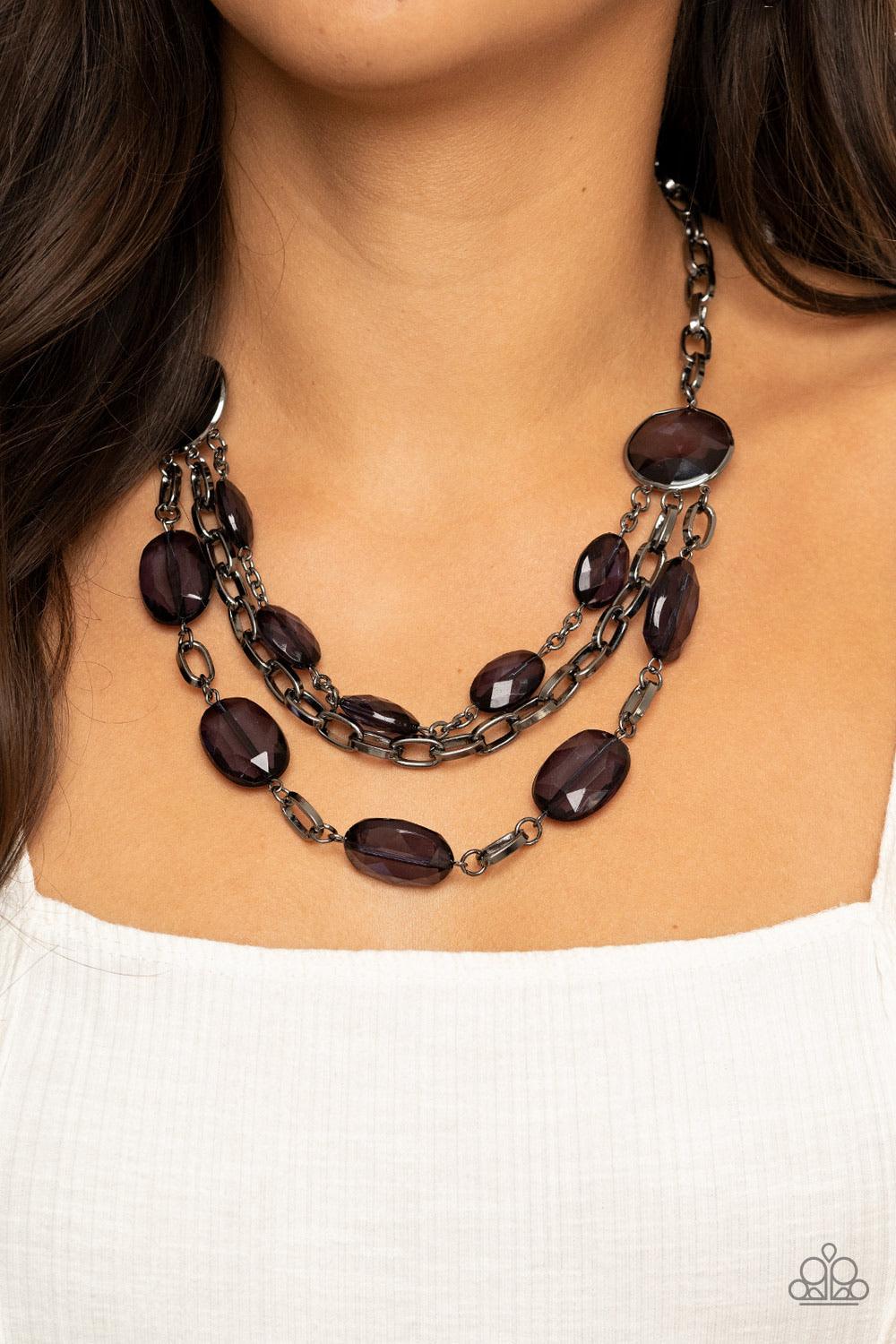 Paparazzi Accessories I Need A GLOW-Cation - Black Strung between two matching black gem-like fittings, two glittery rows of black oval gems flank a strand of bold gunmetal chain below the collar for a flawlessly layered look. Features an adjustable clasp