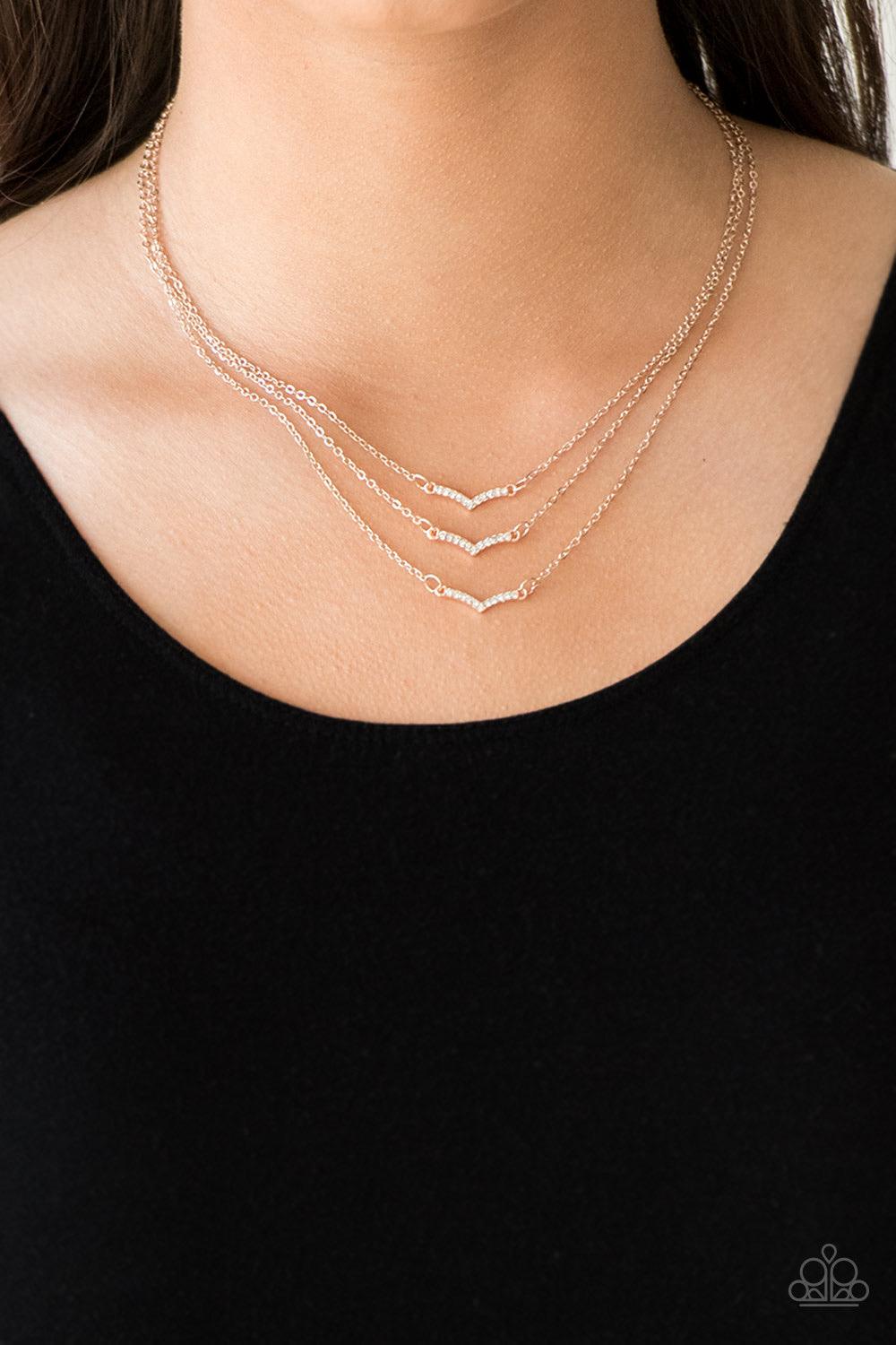 Paparazzi Accessories Pretty Petite - Rose Gold Encrusted in glassy white rhinestones, three dainty rose gold frames layer below the collar for a classic look. Features an adjustable clasp closure. Sold as one individual necklace. Includes one pair of mat