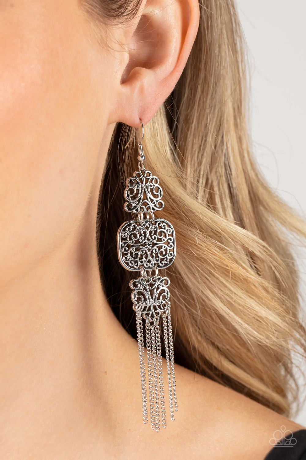 Paparazzi Accessories Eastern Elegance - Silver Filled with vine-like filigree, a trio of mismatched silver frames delicately link into a stacked lure. A curtain of dainty silver chains stream from the bottom of the display, adding playful movement to the