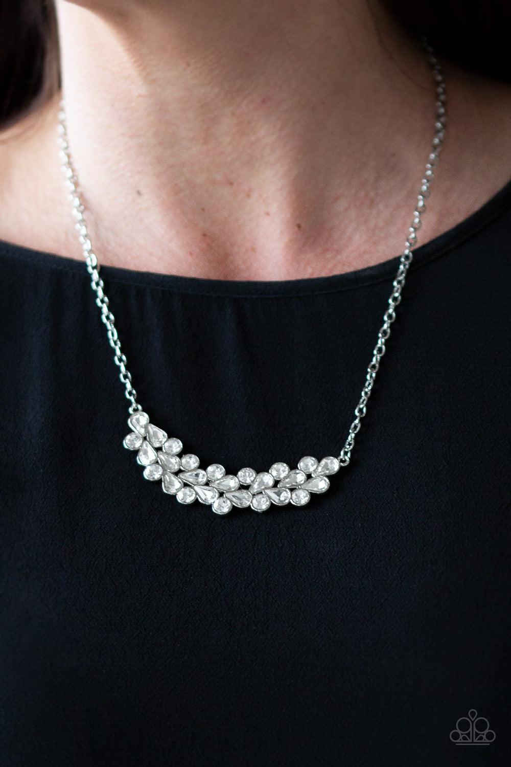 Paparazzi Accessories Special Treatment - White A collection of round and teardrop white rhinestones coalesce into a bowing silver pendant below the collar for a refined look. Features an adjustable clasp closure. Jewelry