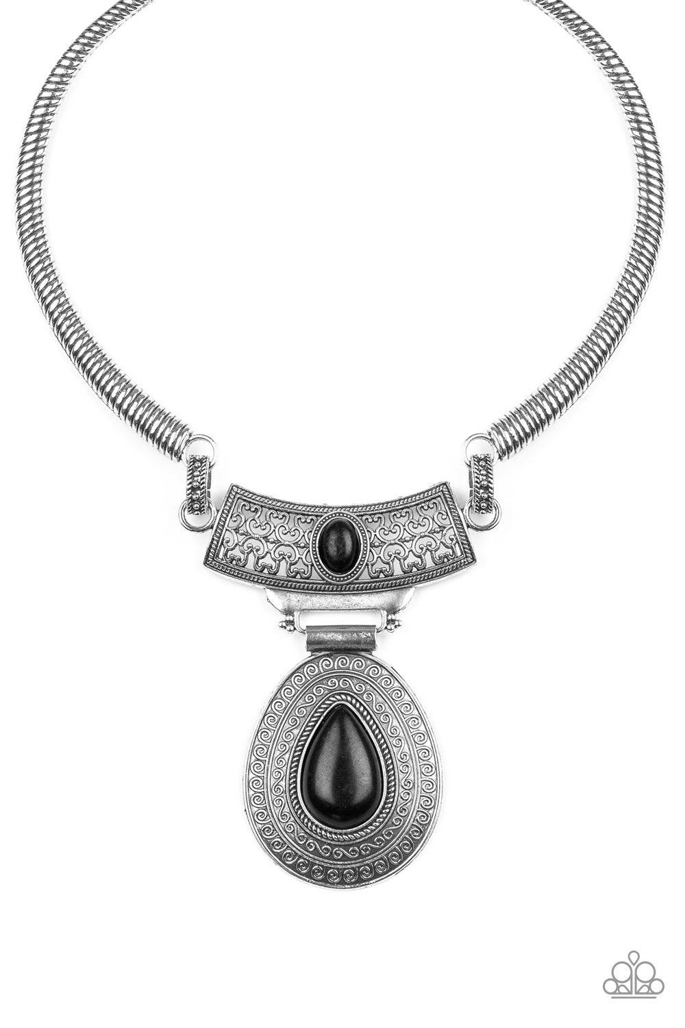Paparazzi Accessories Prowling Prowess - Black Etched in linear textures, bowing silver bars link with an ornate silver plate dotted with an earthy black stone. Embossed in dizzying tribal inspired patterns, an oversized black stone dotted teardrop pendan