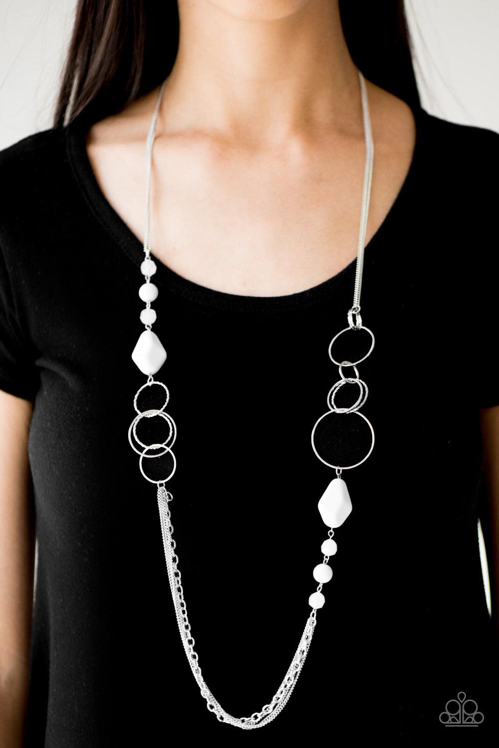 Paparazzi Accessories Wonderfully Colorful ~White Faceted and smooth white beads trickle along sections of shimmery silver hoops. The colorful beading gives way to trestles of mismatched chain, creating bold layers down the chest. Features an adjustable c