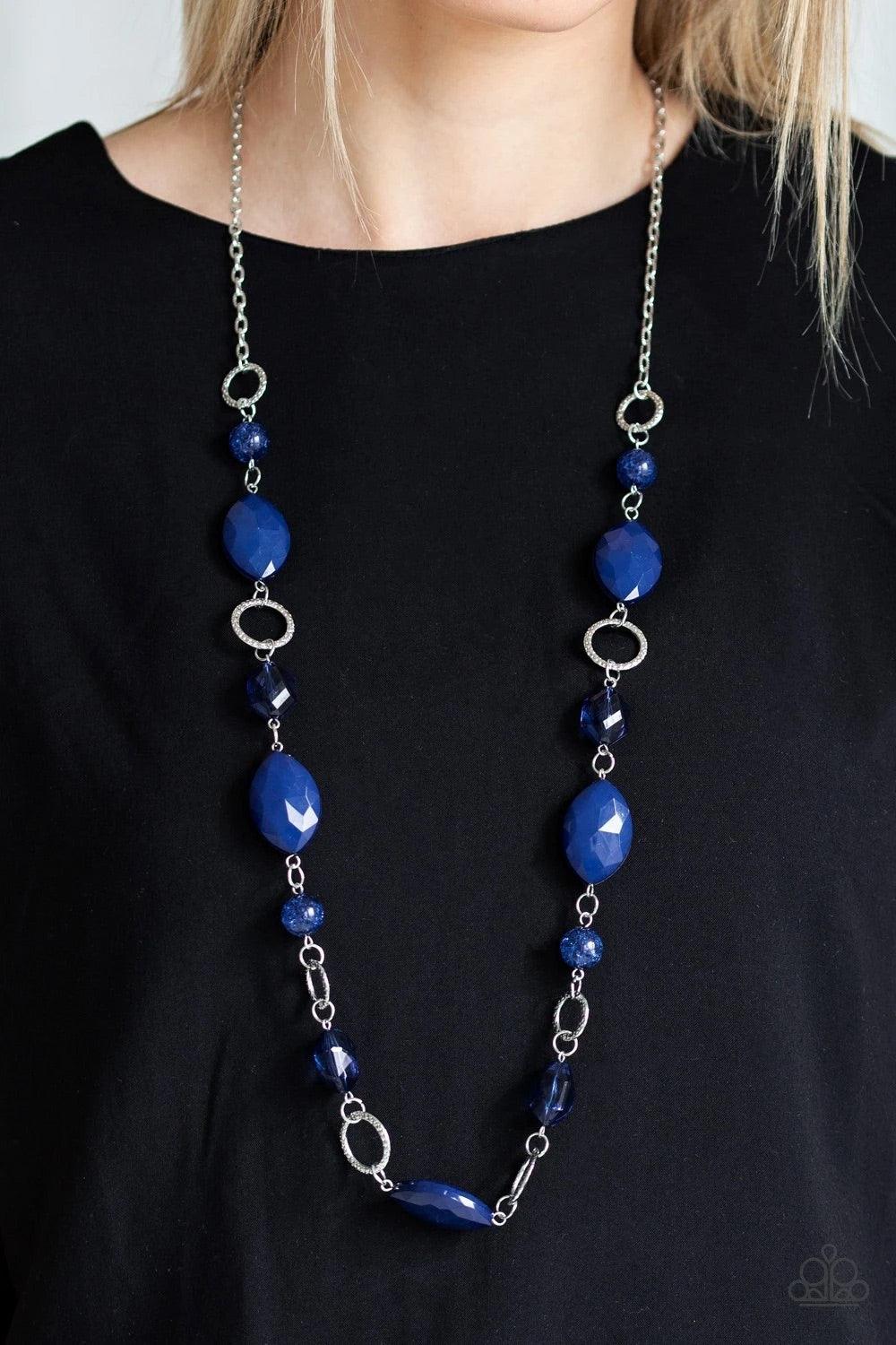 Paparazzi Accessories Shimmer Simmer - Blue A collection of faceted, crystal-like, and sparkling blue beads join across the chest. Hammered silver rings are sprinkled between the colorful accents for a whimsical finish. Features an adjustable clasp closur