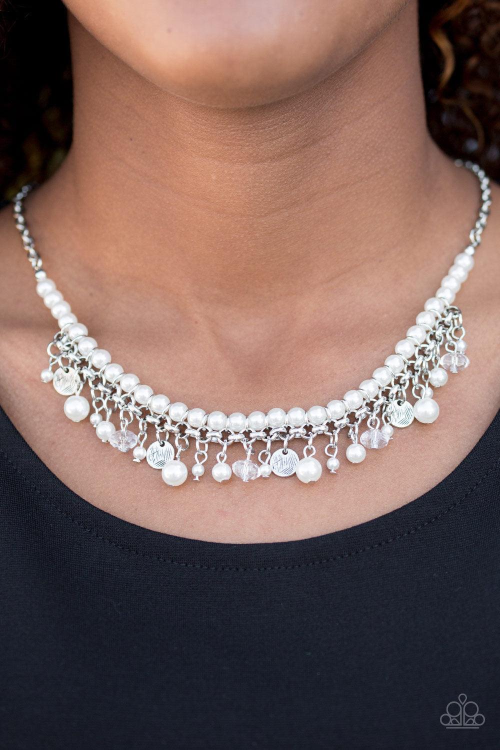 Paparazzi Accessories Glamour Trove - White Swinging from the bottom of a shimmery silver chain, classic white pearls are threaded along an invisible wire, creating a refined look below the collar. Etched in glistening textures, shimmery silver discs, pea