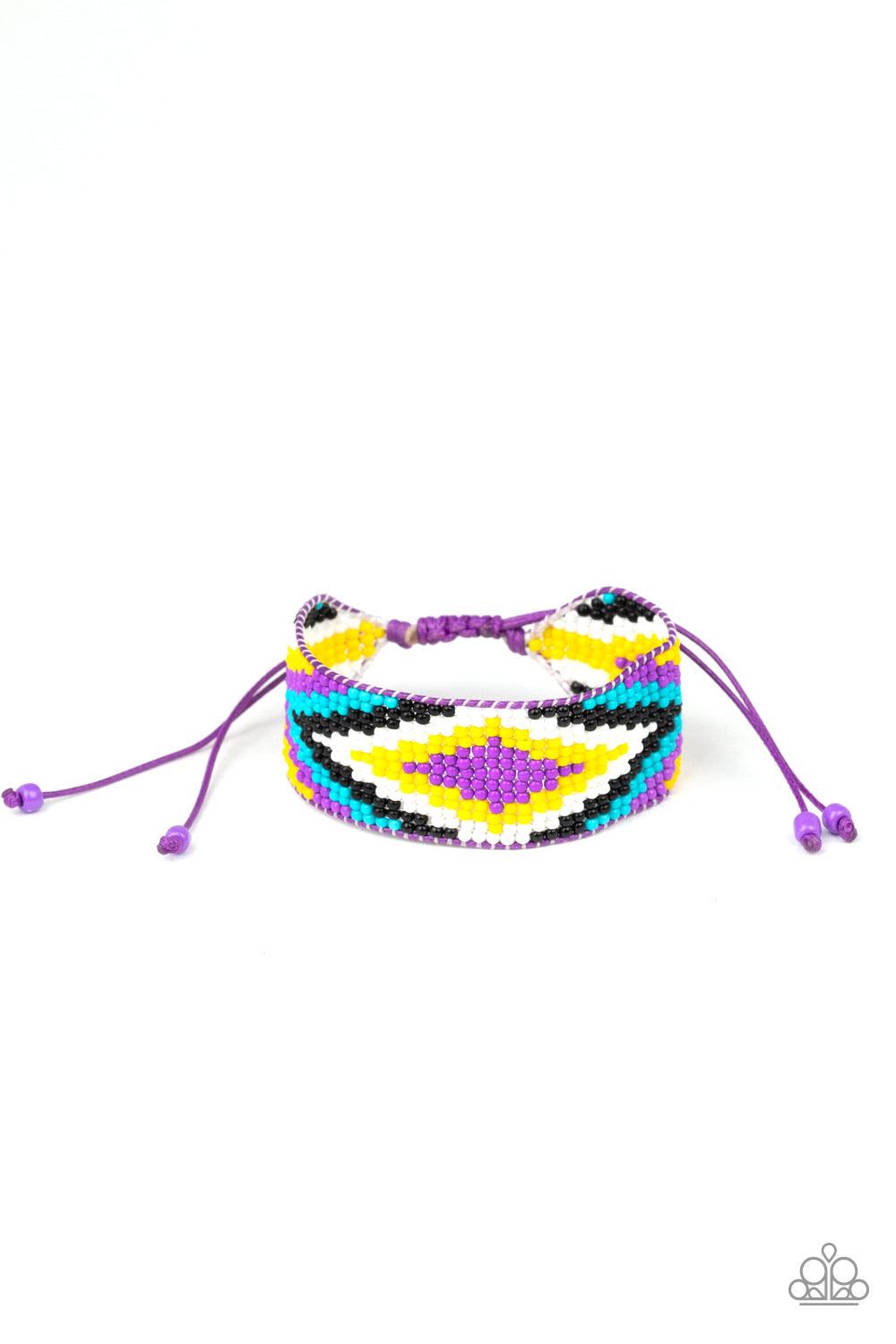 Paparazzi Accessories Beautifully Badlands - Purple Threaded along invisible thread, a dainty collection of purple, blue, black, white, and yellow seed beads weave into a colorful textile pattern across the wrist for a tribal inspired look. Features an ad