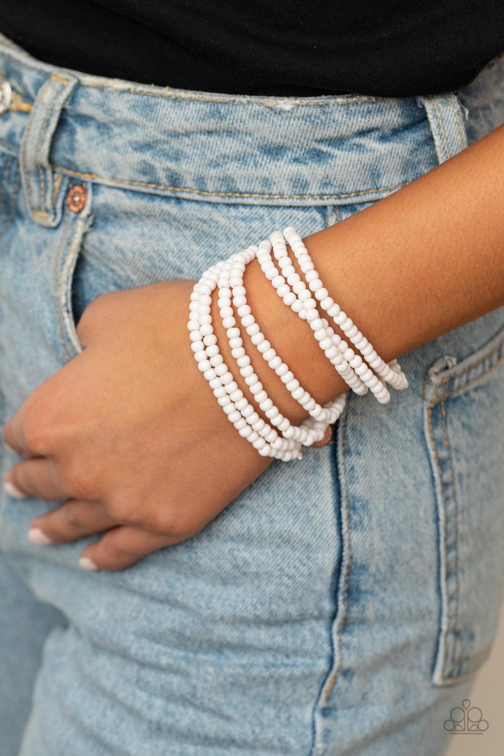 Paparazzi Accessories Thank Me LAYER - White Held together by a dainty silver fitting, a casual collection of white beads are threaded along stretchy bands around the wrist, creating colorful layers. Sold as one individual bracelet. Jewelry