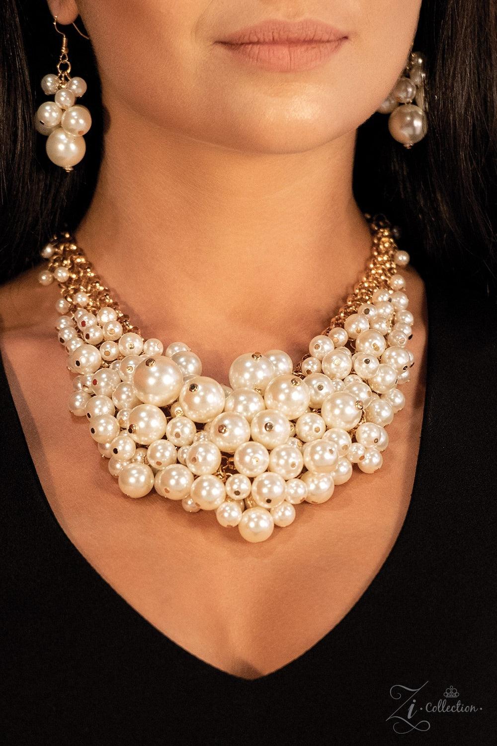 Paparazzi Accessories Exec-YOU-tive Clusters of elegant white pearls swing from a tapered net of interlocking gold chains, creating an effervescent statement piece. The bubbly fringe sits just below the collar, giving off a playfully professional vibe. Fe