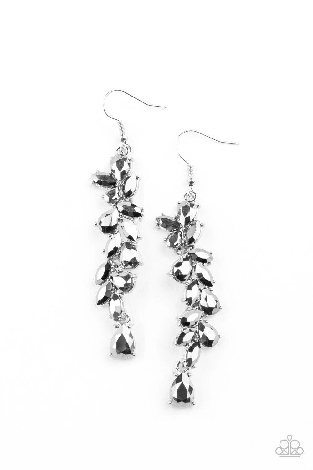 Paparazzi Accessories Unlimited Luster - Silver Twinkling tiers of teardrop and oval hematite rhinestones cascade from the ear, fanning out into a jaw-dropping statement piece. Earring attaches to a standard fishhook fitting. Sold as one pair of earrings.