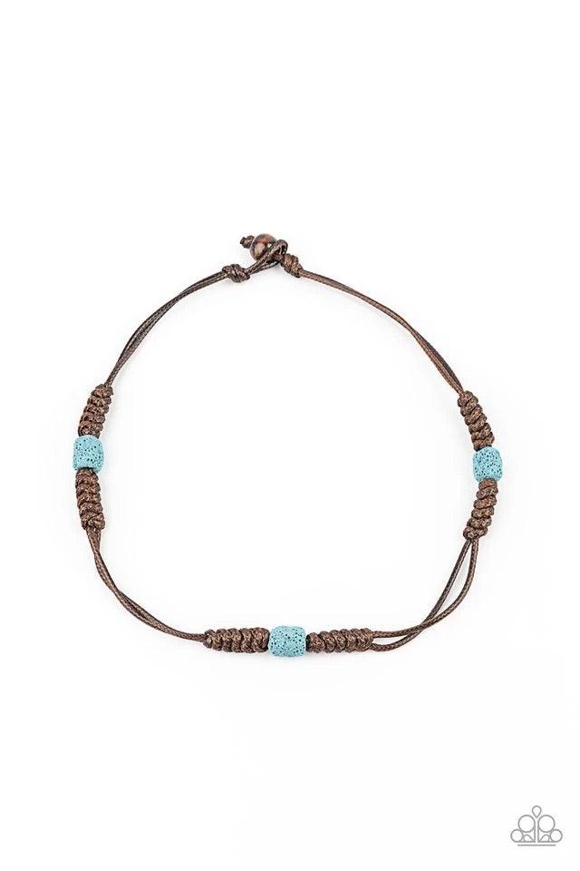 Paparazzi Accessories Volcanic Vagabond - Blue Featuring a refreshing blue finish, pumice-like rock beads are knotted in place along stands of shiny brown cords that braid around the neck for a tropical inspired look. Features a button loop closure. Jewel