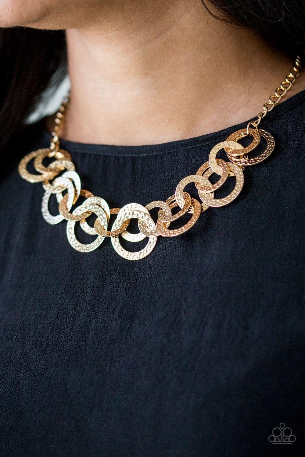 Paparazzi Accessories Treasure Tease - Gold Brushed in a high-sheen shimmer, delicately hammered gold discs connect below the collar for a bold industrial look. Features an adjustable clasp closure. Jewelry