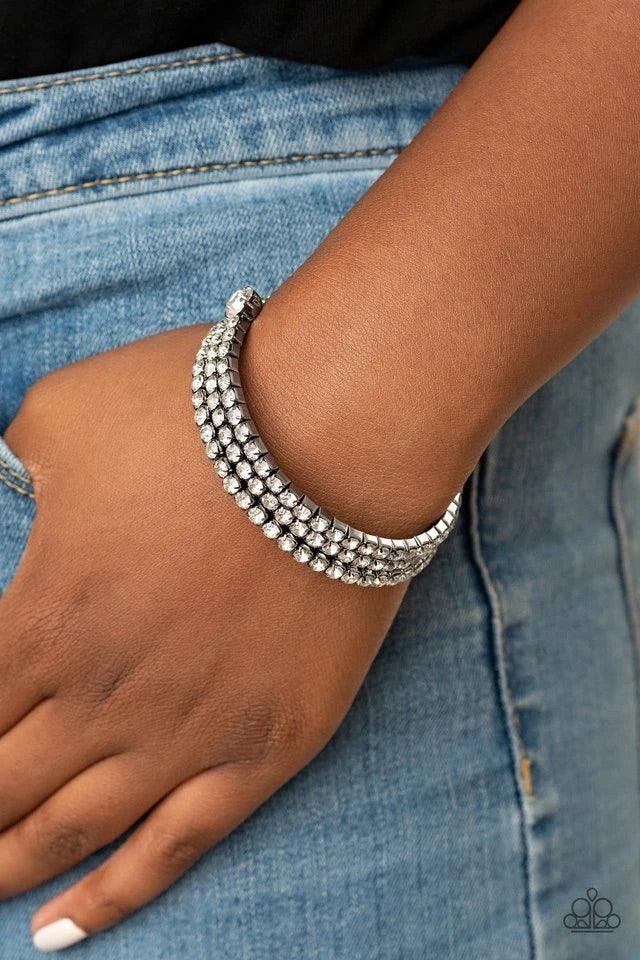 Paparazzi Accessories After Party Princess - Black Featuring two oversized white rhinestone fittings, a glittery collection of white rhinestone encrusted gunmetal frames are threaded along a gunmetal wire around the wrist, creating a glamorous infinity wr