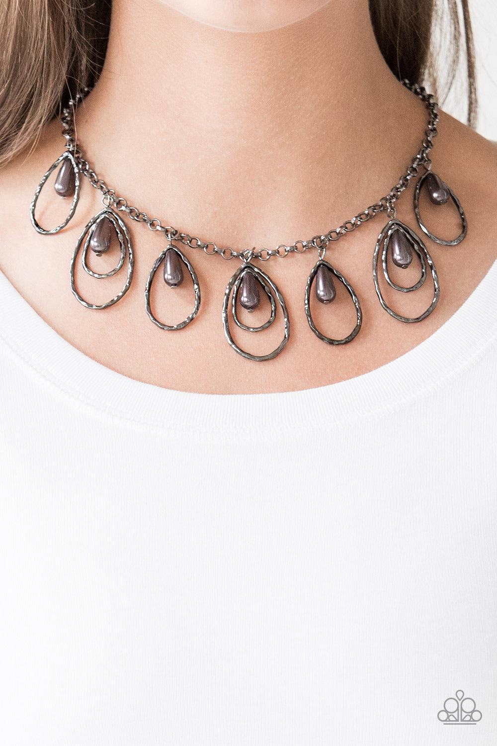 Paparazzi Accessories Rustic Ritz - Black Pearly gunmetal teardrop beads swing from the tops of delicately hammered gunmetal teardrop frames, creating a refined fringe below the collar. Features an adjustable clasp closure. Sold as one individual necklace
