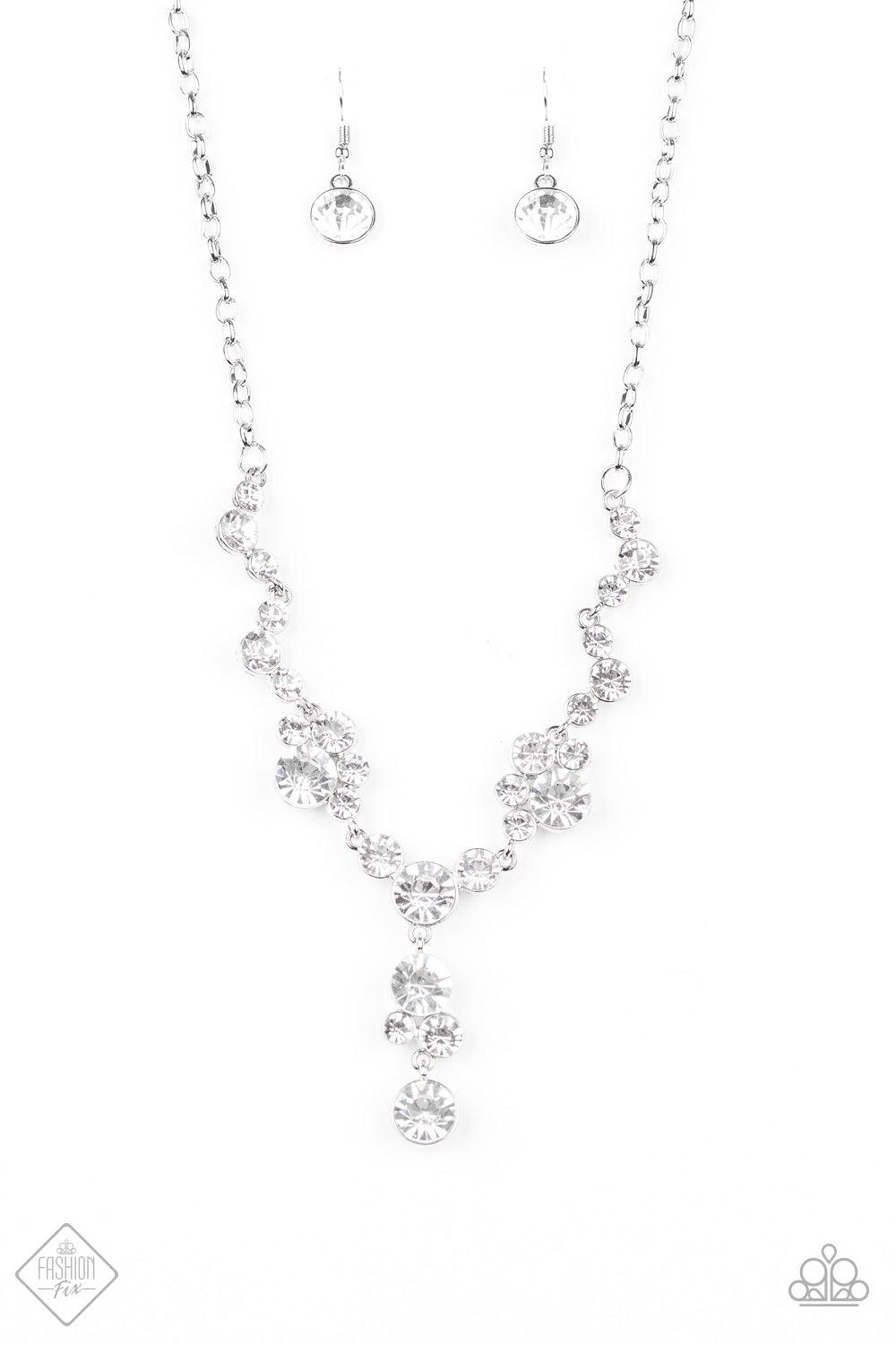 Paparazzi Accessories Inner Light - White A collection of glassy white rhinestone encrusted frames link below the collar in a timeless fashion. A matching rhinestone encrusted frame and oversized white gem dangle from the bottom, creating a glamorous exte