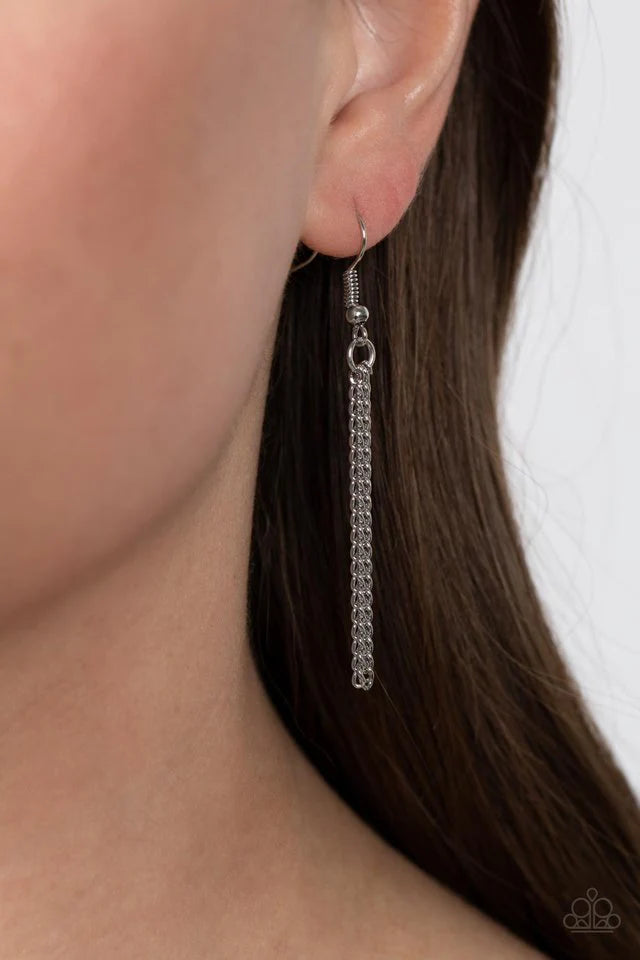 Paparazzi Accessories Trailblazing Talisman - Green This lucky charm features a polished jade stone that lies below a hammered silver metal bar and a shiny silver starburst top. The earthy pendant swings from the bottom of a lengthened silver chain, resul