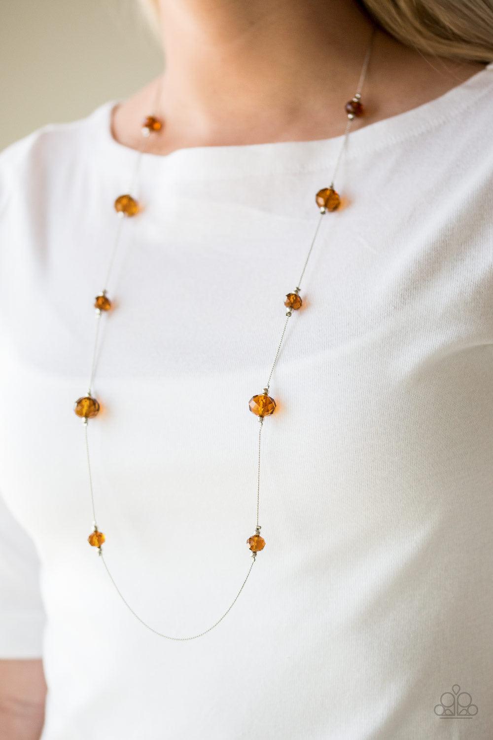 Paparazzi Accessories Champagne On The Rocks - Brown Infused with dainty silver accents, glittery brown crystal-like beads trickle along a dainty silver chain across the chest for a refined look. Features an adjustable clasp closure. Sold as one individua