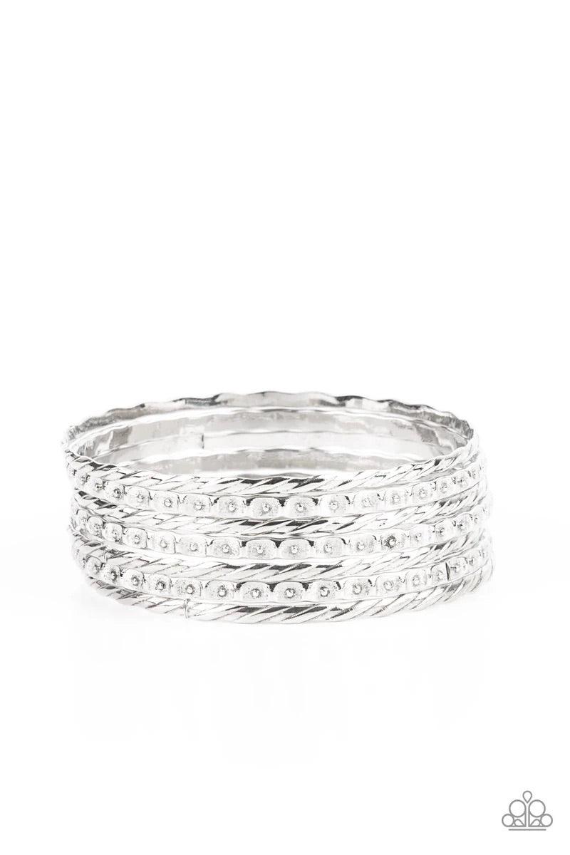 Paparazzi Accessories Back-To-Back Stacks - Silver Embossed in slanted ribbons of textured and studded hammered patterns, trios of mismatched silver bangles stack across the wrist for an intense industrial vibe. Sold as one set of six bracelets. Jewelry
