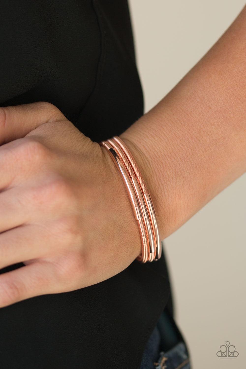 Paparazzi Accessories It’s A Stretch - Copper A collection of shiny copper accents slide along stretchy spring-like wires for a sleek industrial look. Jewelry
