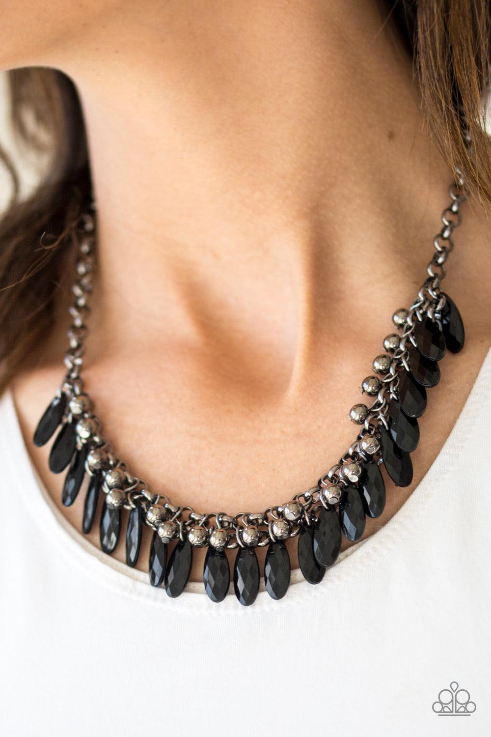 Paparazzi Accessories Jersey Shore - Black Faceted black teardrops and glistening gunmetal beads swing from the bottom of interlocking gunmetal chains, creating a spunky fringe below the collar. Features an adjustable clasp closure. Sold as one individual