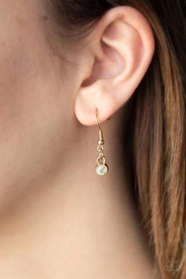 Paparazzi Accessories Constellation Collection - Multi Varying in shape and size, triangular, round, and square cut iridescent rhinestones coalesce into a floating pendant at the bottom of doubled gold chains, creating a stellar shimmer below the collar.