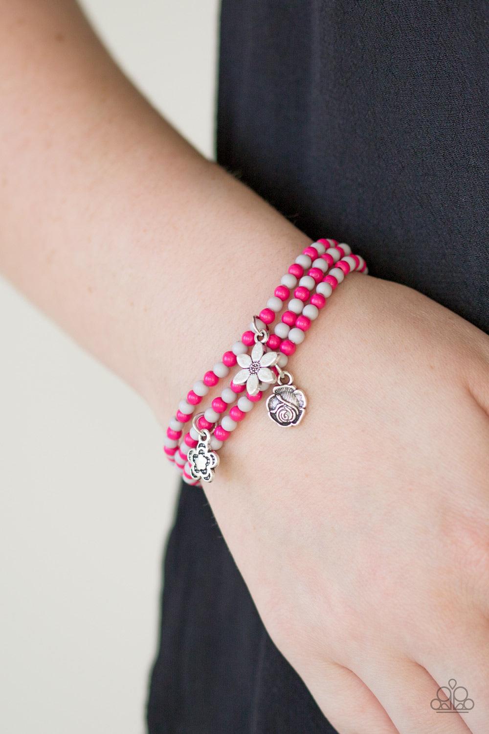 Paparazzi Accessories Rooftop Gardens - Pink Dainty pink and gray beads are threaded along stretchy elastic bands, creating colorful layers across the wrist. Brushed in an antiqued shimmer, dainty floral charms swing from the wrist for a seasonal finish.