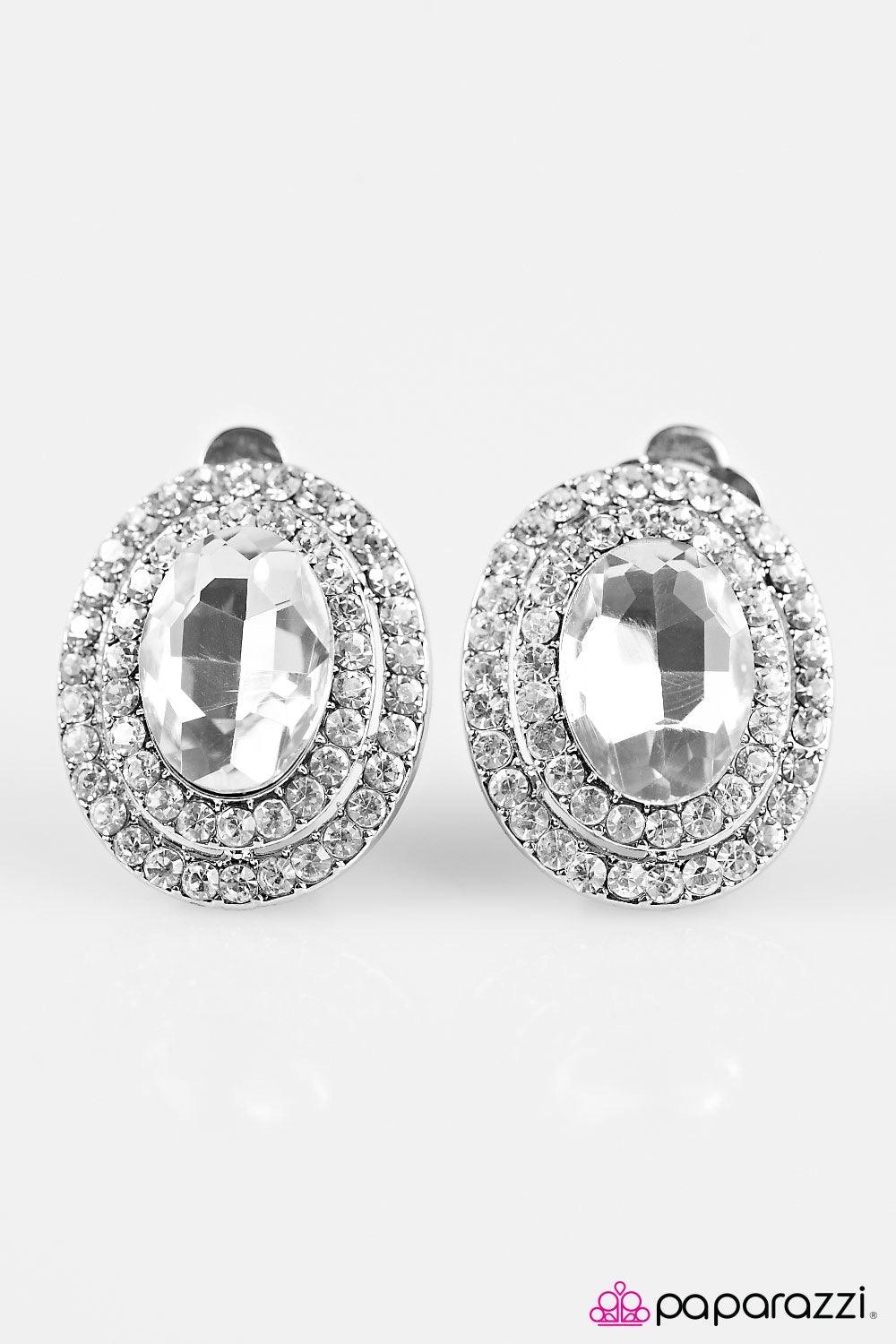 Paparazzi Accessories All For The Shimmer - White *Clip-On Two frames of dazzling white rhinestones spin around a glassy center, creating classic shimmer from any angle. Earring attaches to a standard clip-on fitting. Jewelry