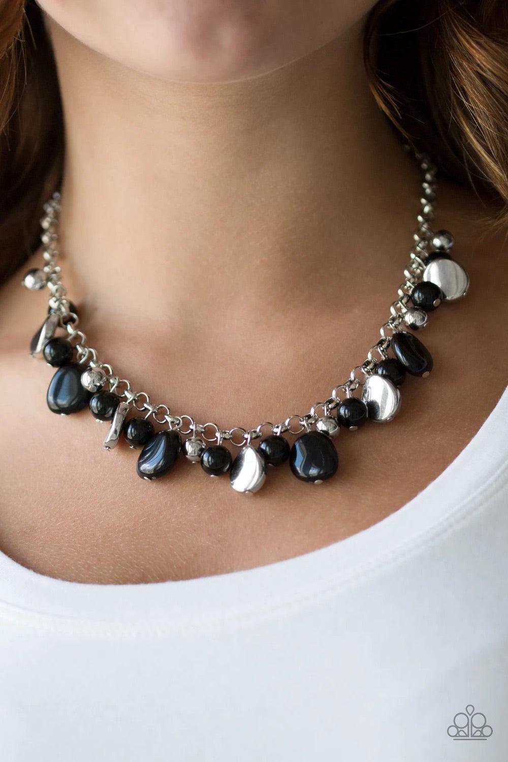 Paparazzi Accessories Flirtatiously Florida - Black Featuring round and asymmetrical shapes, shiny silver and black beads swing from the bottom of a bold silver chain, creating a flirtatious fringe below the collar. Features an adjustable clasp closure. S
