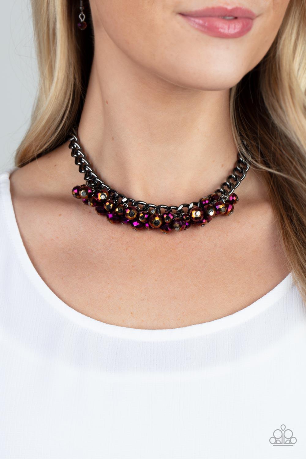 Paparazzi Accessories Galactic Knockout - Purple Flecked in oil spill iridescence, a faceted collection of metallic beads cluster along the center of a chunky gunmetal curb chain, creating a stellar fringe below the collar. Features an adjustable clasp cl