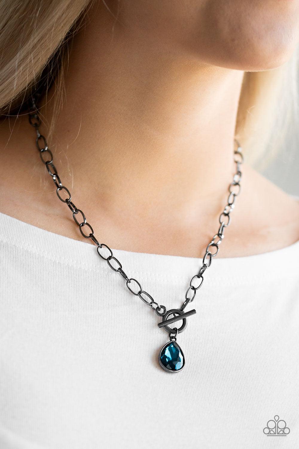 Paparazzi Accessories So Sorority - Blue A faceted blue teardrop gem swings from the bottom of a glistening gunmetal chain, creating a classic pendant below the collar. Features a toggle closure. Sold as one individual necklace. Includes one pair of match