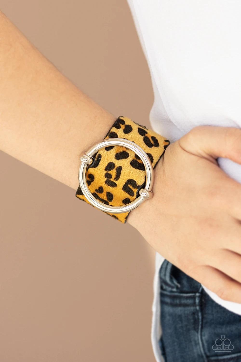 Paparazzi Accessories Asking FUR Trouble - Yellow A dramatically oversized silver ring slides along a thick black leather band featuring fuzzy yellow cheetah print for a wild finish. Features an adjustable snap closure. Sold as one individual bracelet. Je