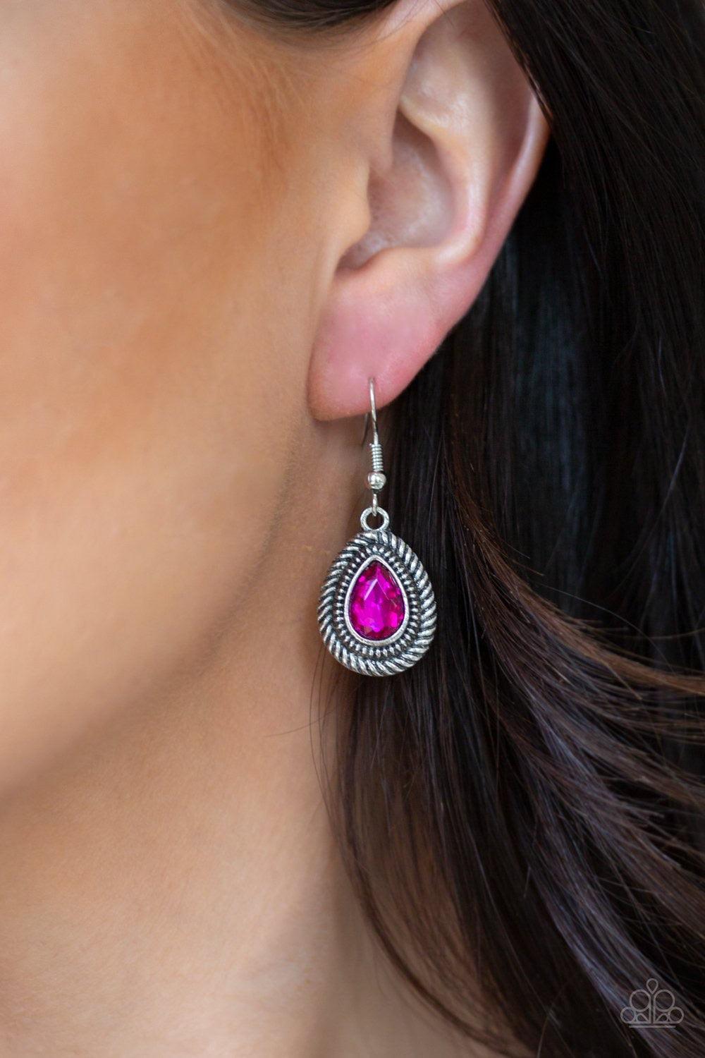 Paparazzi Accessories Sheen Queen - Pink A faceted pink teardrop gem is pressed into a textured silver frame. The glamorous pendant swings from a shimmery silver hoop below the collar for statement-making fashion. Features a toggle closure. Jewelry