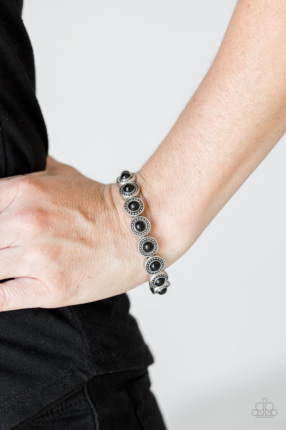 Paparazzi Accessories Globetrotter Goals - Black Dotted with shiny black beaded centers, studded silver frames are threaded along stretchy elastic bands and linked around the wrist for a whimsical look. Sold as one individual bracelet. Jewelry
