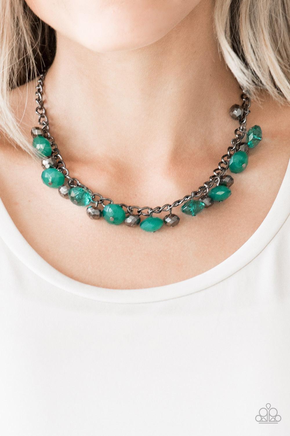 Paparazzi Accessories Runway Rebel - Green Featuring cloudy and glassy finishes, faceted green crystal-like beads swing from the bottom a glistening gunmetal chain. Faceted gunmetal beads join the fiery beading, creating a flirtatious fringe below the col