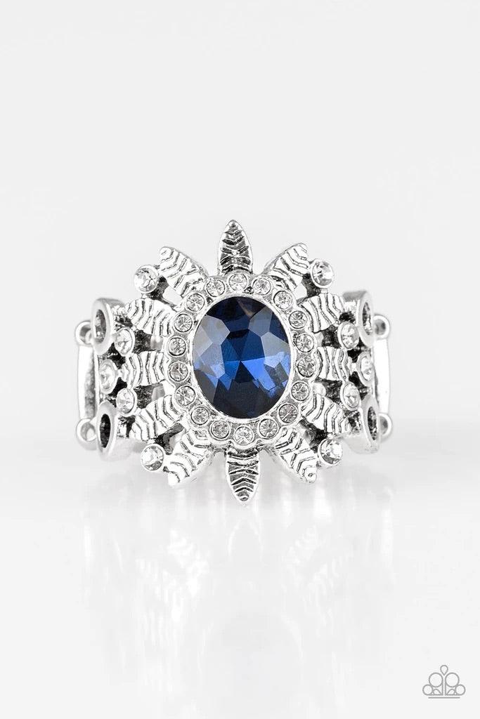 Paparazzi Accessories Burn Bright - Blue Ringed in glittery white rhinestones, a glittery blue gem is pressed into the center of a leafy silver frame. Dainty white rhinestones are sprinkled along the shimmery foliage for a refined finish. Features a stret