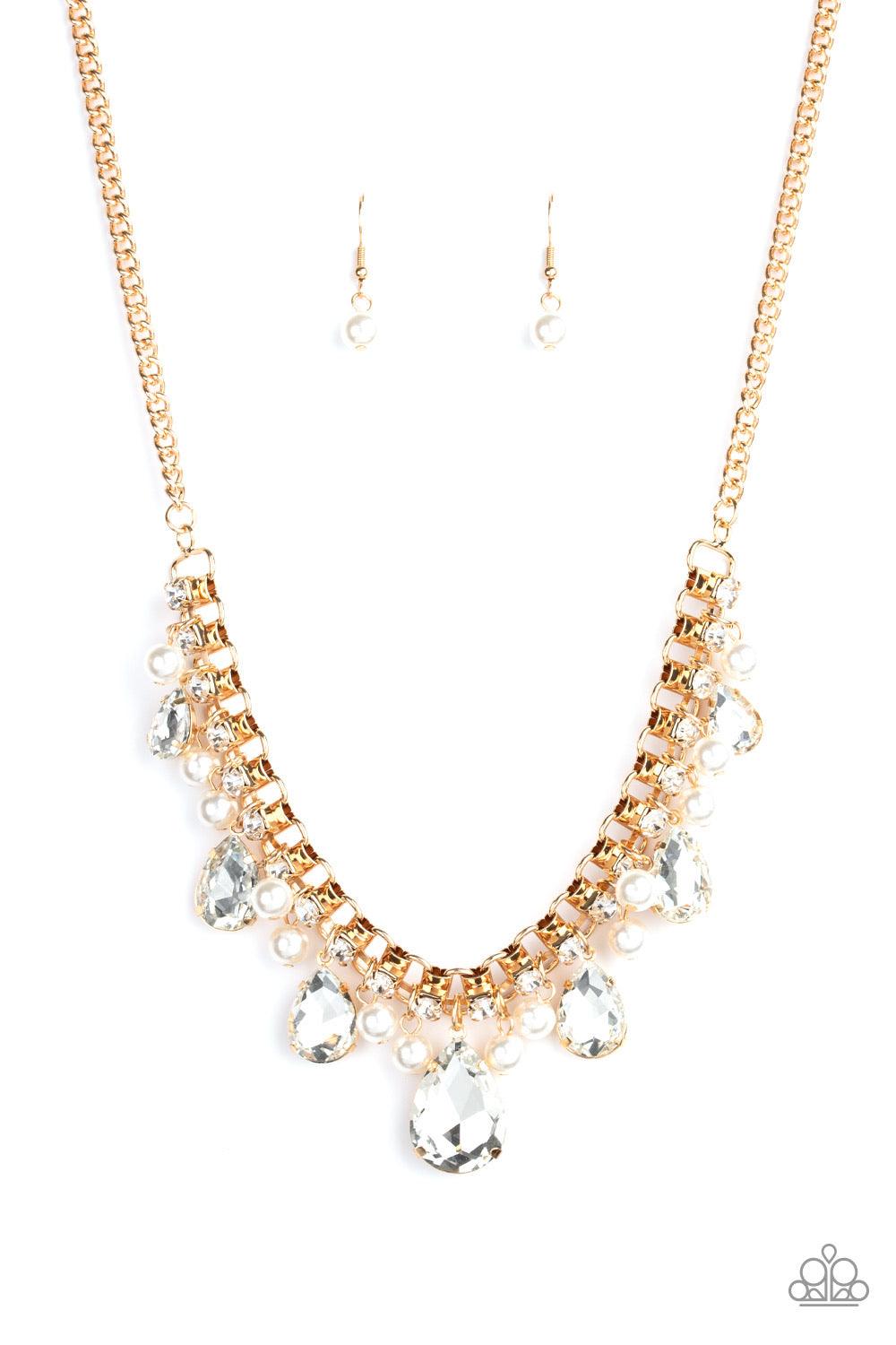 Paparazzi Accessories Knockout Queen - Gold A glamorous collection of bubbly white pearls and exaggerated white teardrop gems dangle from a bold strand of white rhinestones, creating a knockout fringe below the collar. Features an adjustable clasp closure