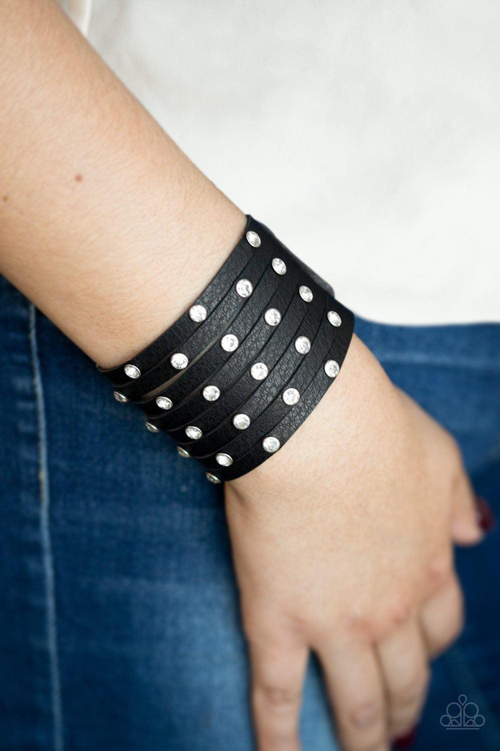 Paparazzi Accessories Sass Squad - Black A thick black leather band has been spliced into numerous black strands. Featuring sleek black frames, glittery white rhinestones are sprinkled across the leather bands for a sassy finish. Features an adjustable sn