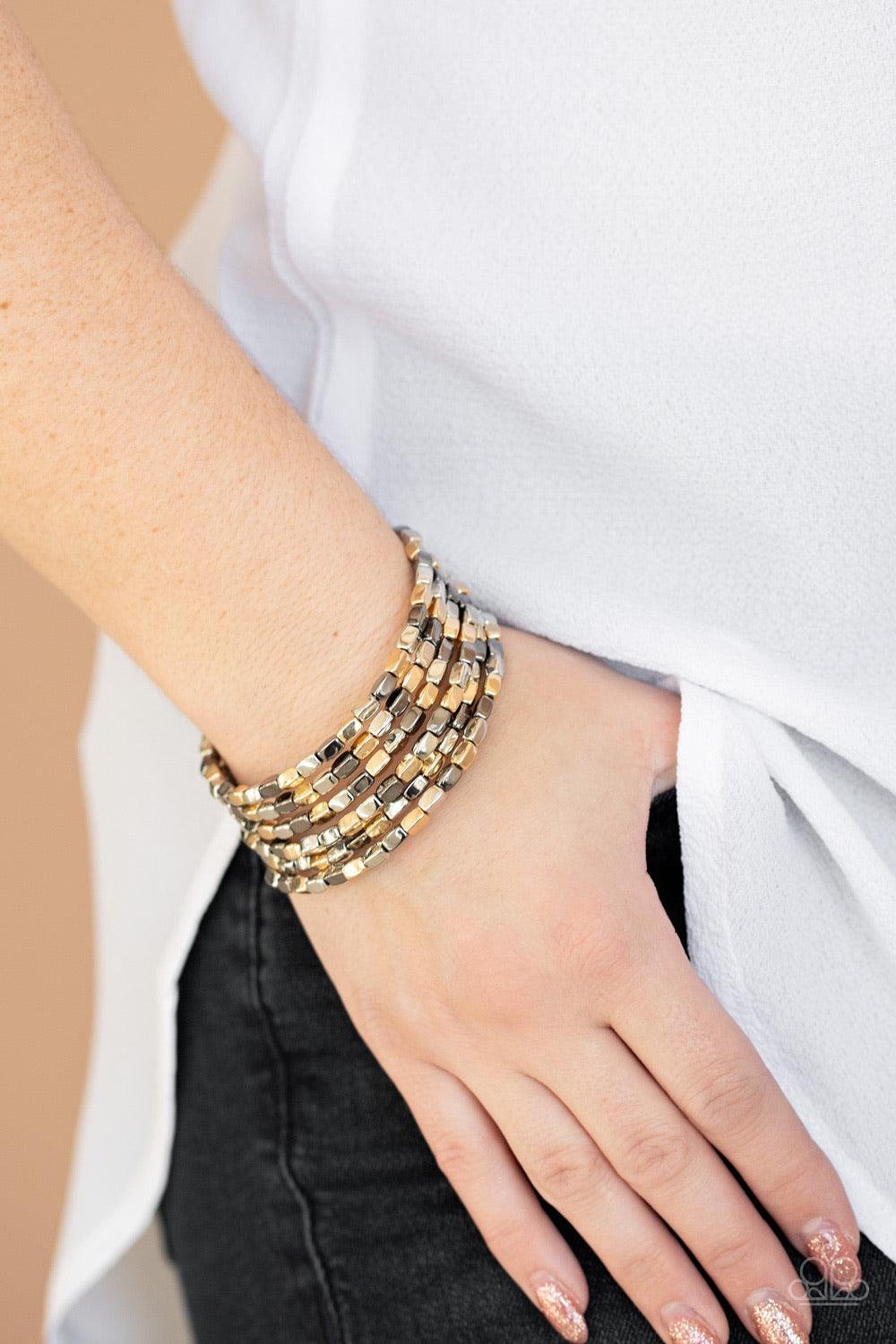 Paparazzi Accessories Stunningly Stacked - Multi A glistening collection of rectangular gold, gunmetal, and silver beads are threaded along a coiled wire, creating a shimmery infinity wrap style bracelet around the wrist. Jewelry