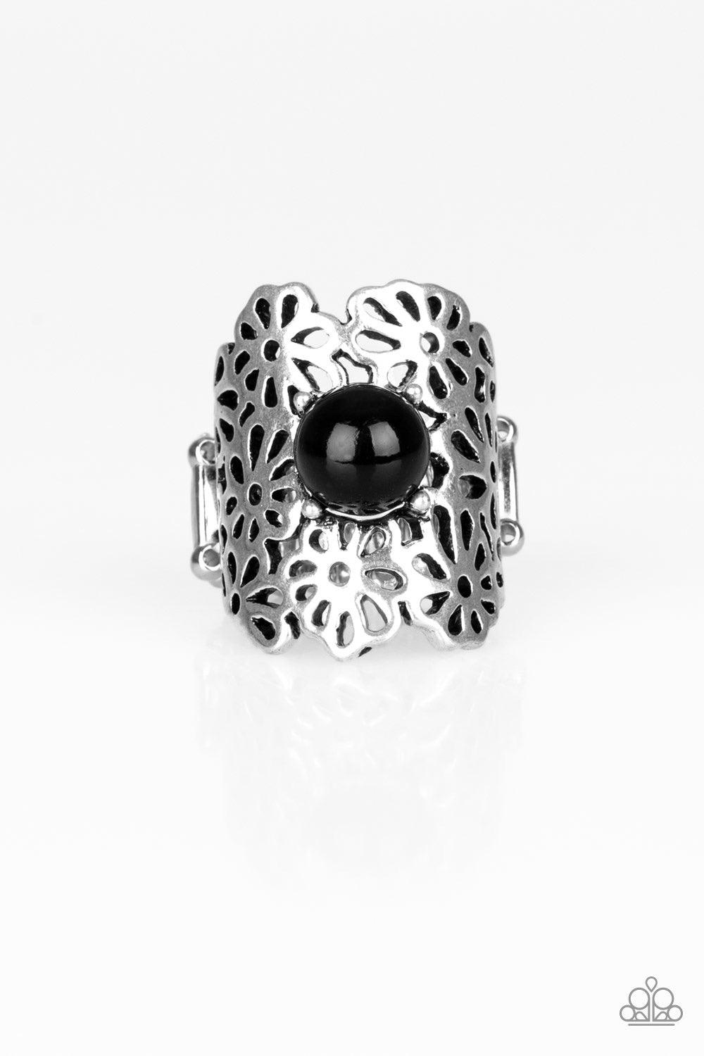 Paparazzi Accessories Flower Shower - Black A collection of airy silver flowers coalesce into a thick silver band. A polished black bead dots the center, adding a perfect pop of color to the seasonal piece. Features a stretchy band for a flexible fit. Sol