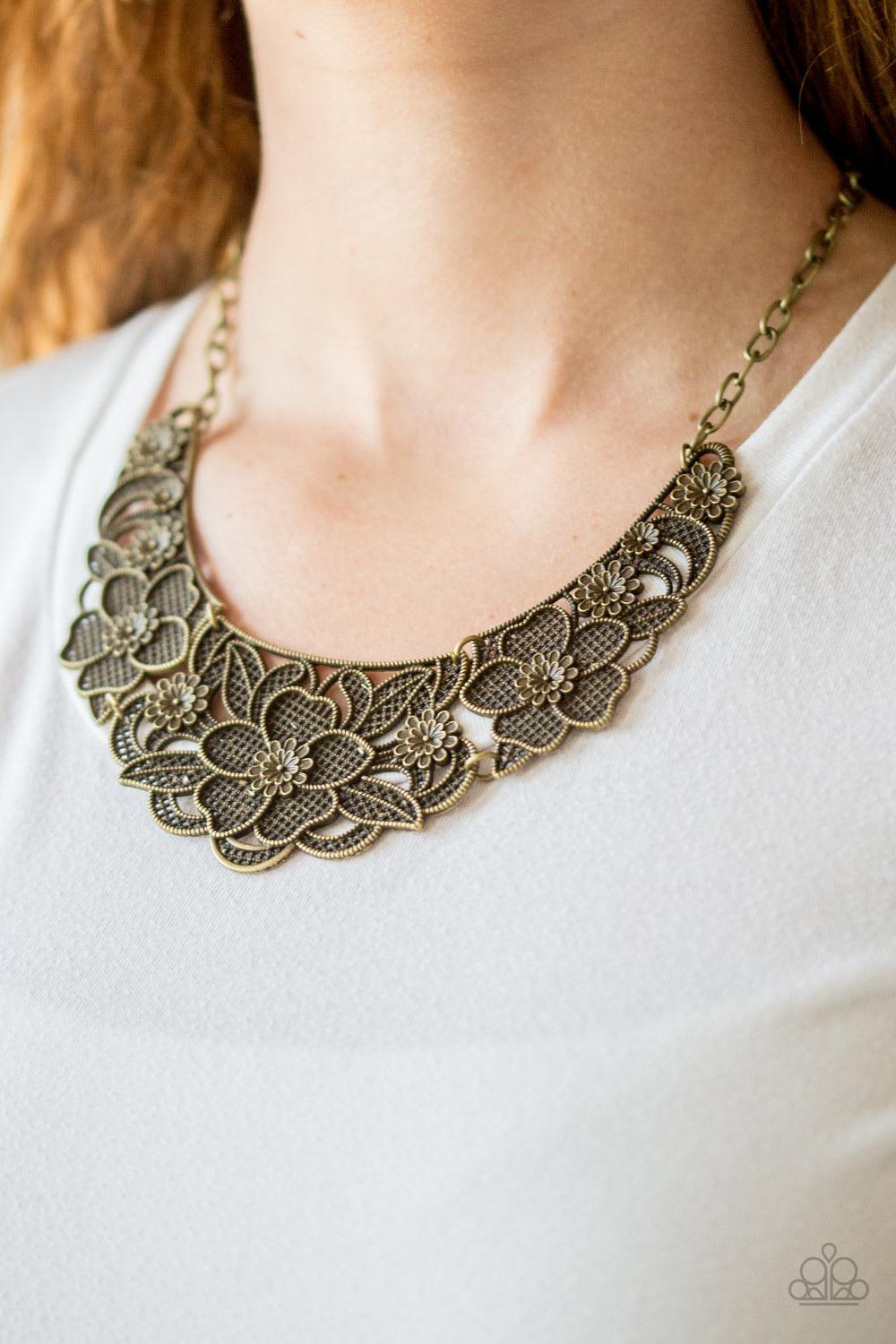 Paparazzi Accessories Petunia Paradise - Brass Featuring lattice-like patterns, shimmery brass flowers bloom below the collar for a seasonal look. Features an adjustable clasp closure. Sold as one individual necklace. Includes one pair of matching earring