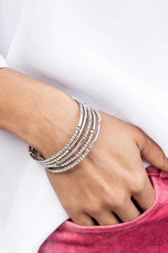 Paparazzi Accessories Camera Shy Simmer - Multi A dainty infinity style bracelet is infused with glittery rows of iridescent rhinestones and curving silver frames, creating simmering layers around the wrist. Sold as one individual bracelet. Jewelry