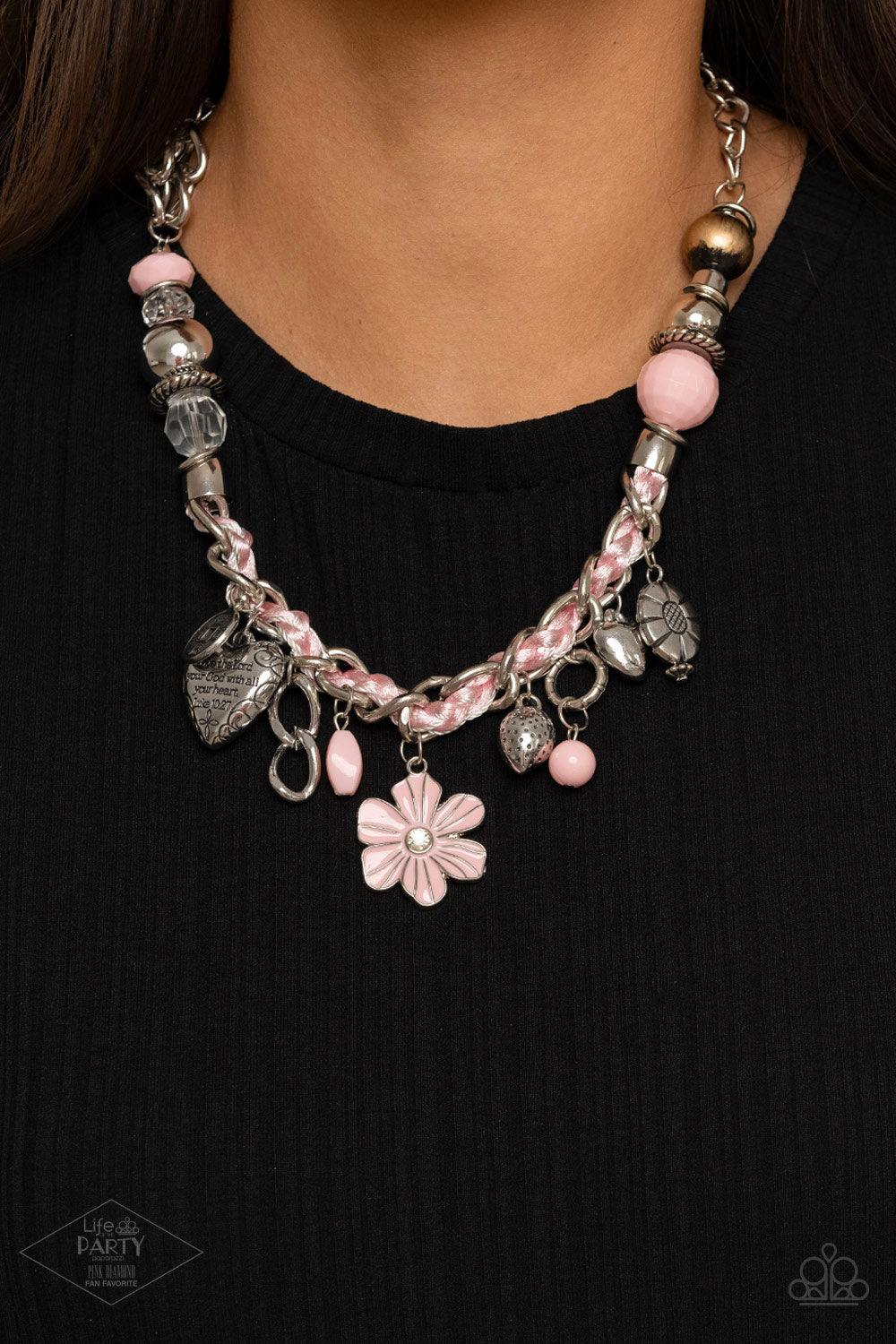 Paparazzi Accessories Charmed, I Am Sure - Pink Pink cording is braided through a chunky silver chain. A unique variety of charms decorate the piece including a delicate flower and a heart inscribed with the phrase "With All My Heart" on one side and a sh