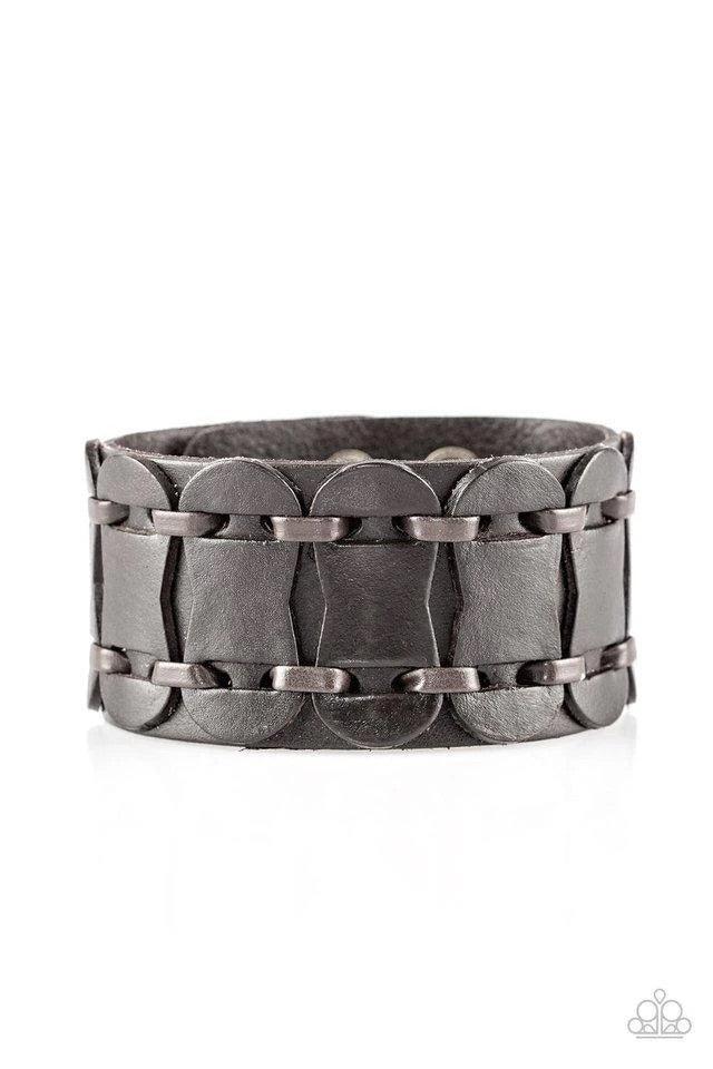 Paparazzi Accessories Traffic Control - Brown Brown leather cording laces through rounded leather pieces, securing the leather accents across the front of a thick leather band for an urban look. Features an adjustable snap closure. Sold as one individual