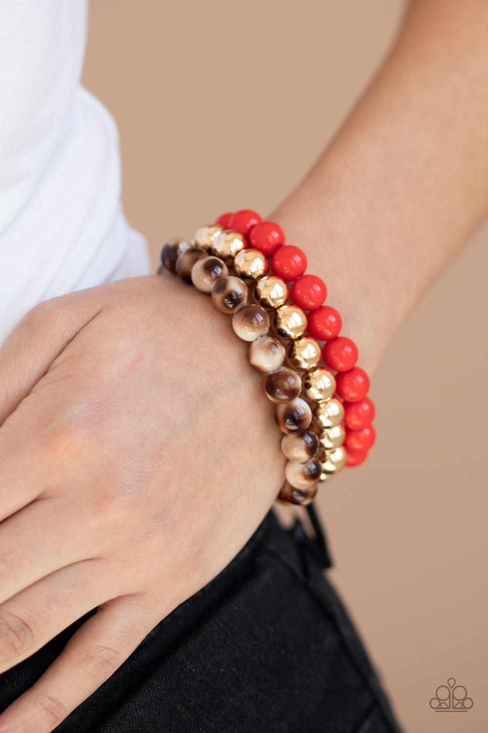Paparazzi Accessories Courageously Couture - Red Strands of red, gold, and brown tortoise-like beads are threaded along stretchy bands around the wrist, creating colorful layers. Jewelry