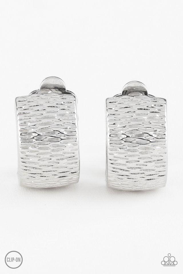 Paparazzi Accessories Cirque Du Couture - Silver *Clip-On Rippling with tactile textures, a shimmery silver ribbon curls into an edgy frame for a causal look. Earring attaches to a standard clip-on fitting. Jewelry