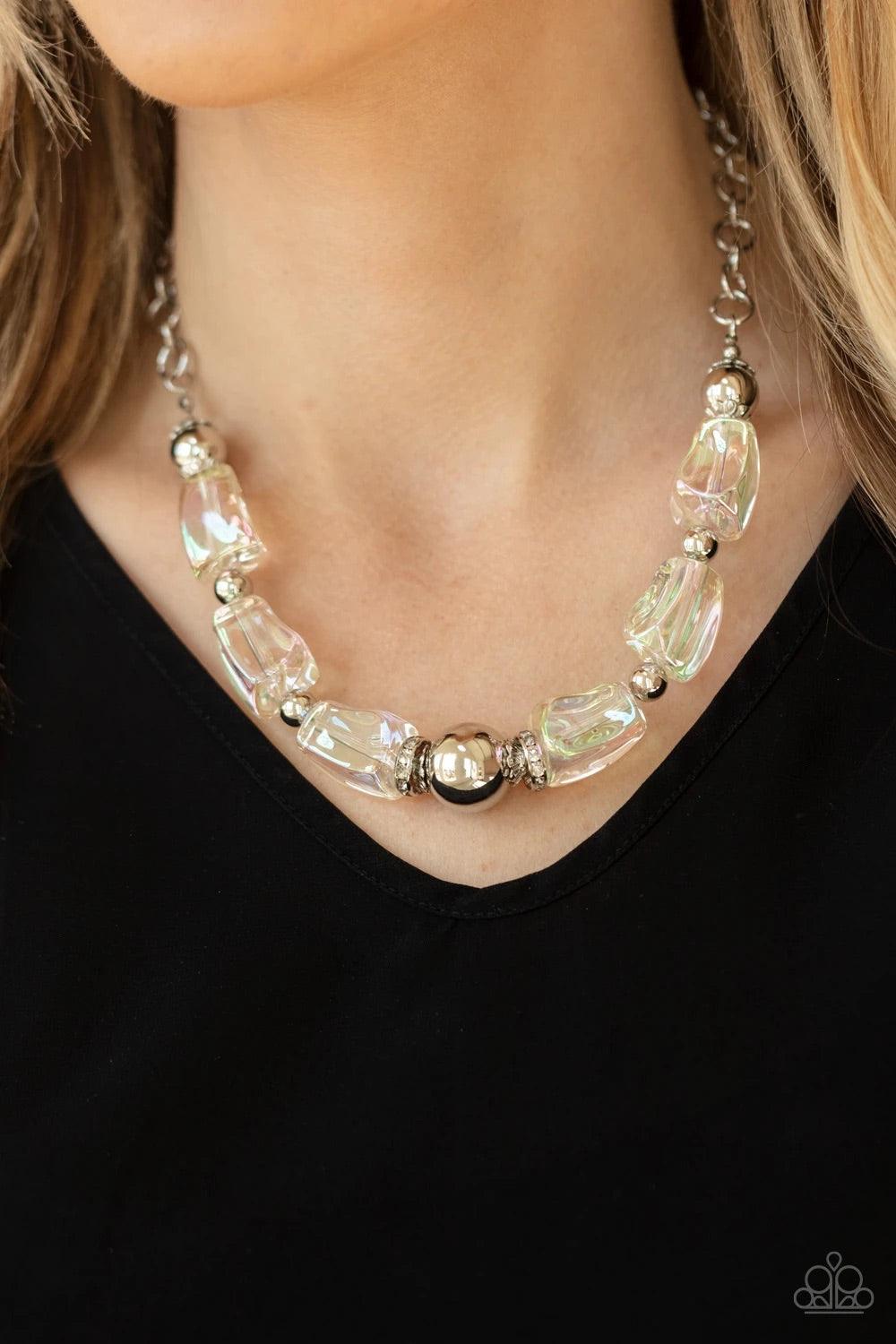Paparazzi Accessories Iridescently Ice Queen - Multi Featuring an icy iridescence, glassy asymmetrical beads joins a mismatched collection of silver beads, white rhinestone encrusted rings, and scalloped silver accents below the collar. Attached to a silv
