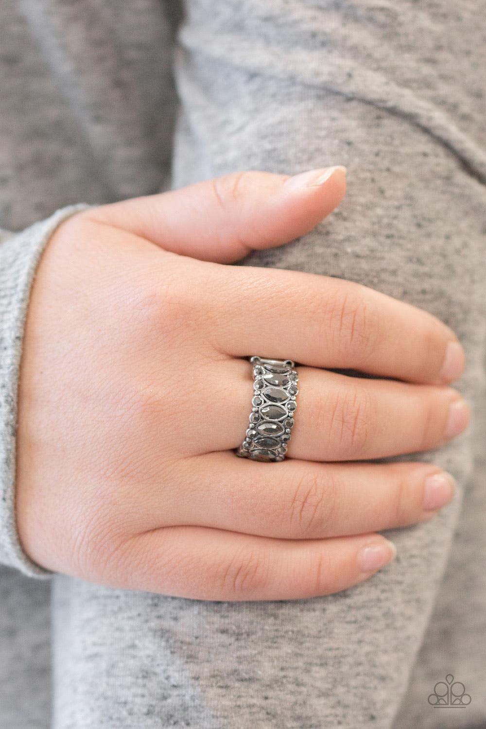 Paparazzi Accessories Radical Riches - Silver Featuring regal marquise style cuts, glittery hematite rhinestones are encrusted down the center of a silver band radiating with glassy hematite rhinestones for an edgy look. Features a stretchy band for a fle