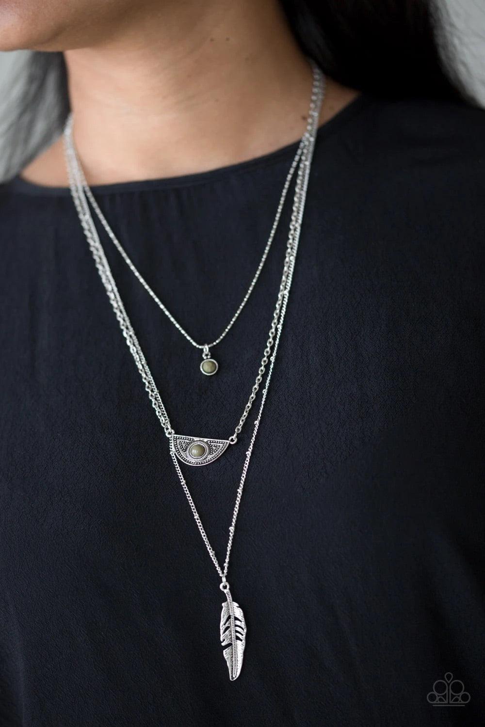 Paparazzi Accessories Sahara Sparrow - Green Featuring indigenous inspired pendants, mismatched silver chains layer down the chest for a seasonal look. Featuring earthy green beaded accents, dainty silver frames give way to a lifelike silver feather penda