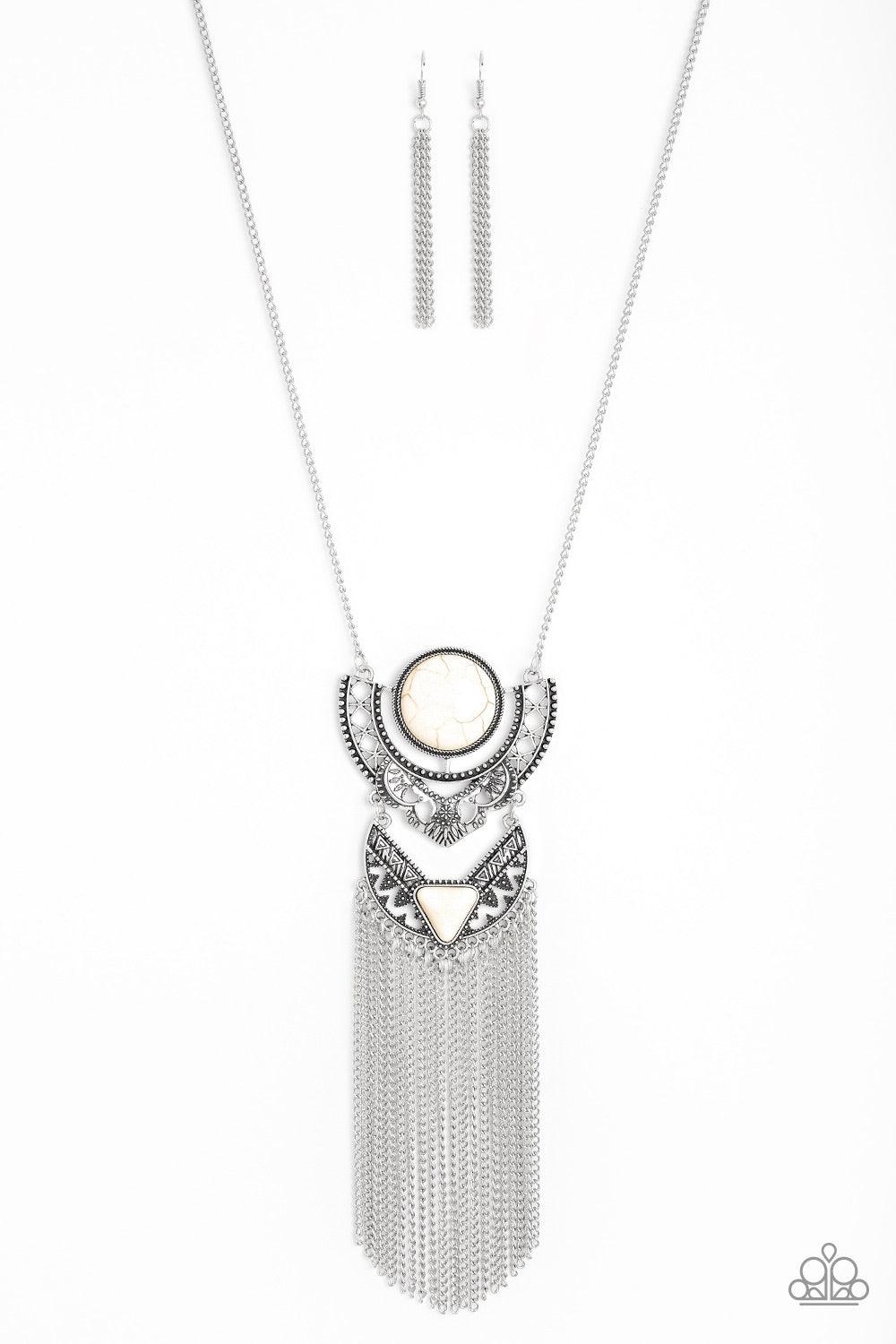 Paparazzi Accessories Spirit Trek - White Featuring refreshing white stone accents, ornate silver plates link at the bottom of a lengthened silver chain for a dramatic tribal look. Shimmery silver chains stream from the bottom of the stacked pendant, addi