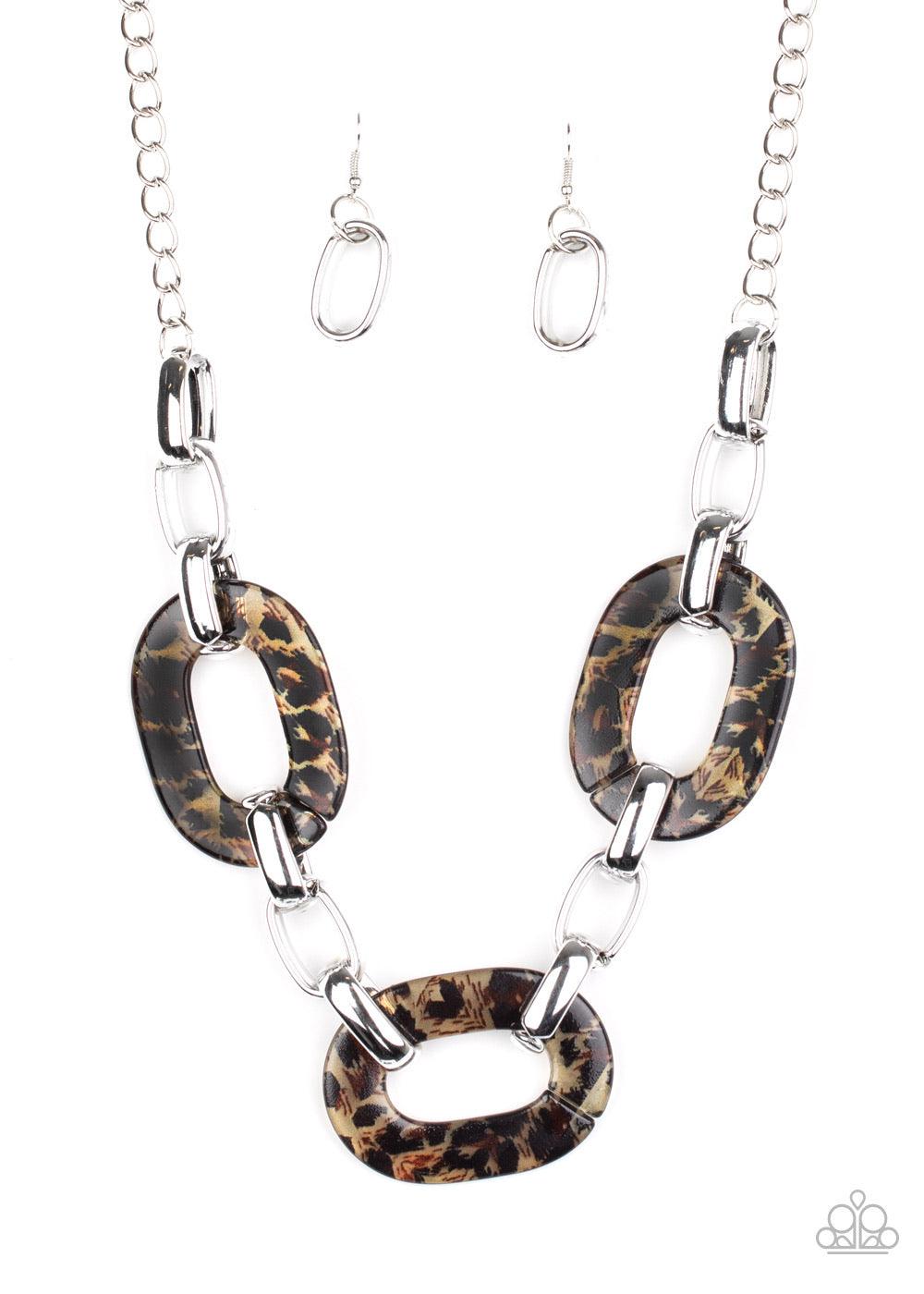 Paparazzi Accessories Sink Your Claws In - Brown Featuring a brown cheetah print, oversized acrylic links delicately join with exaggerated silver links below the collar for a wild look. Features an adjustable clasp closure. Sold as one individual necklace