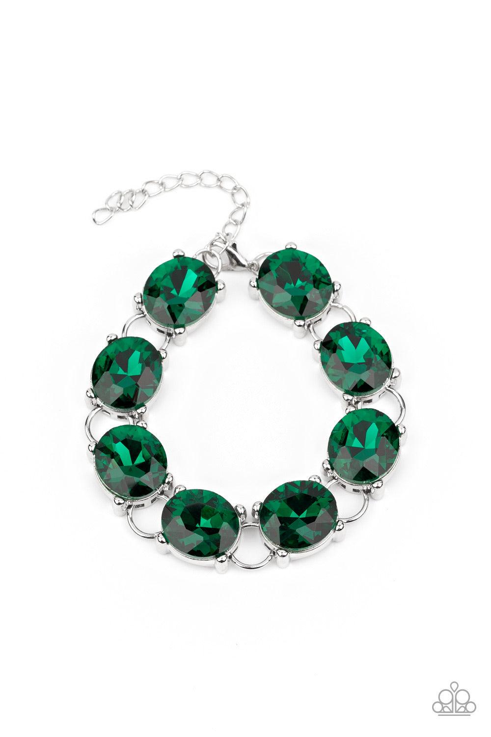 Paparazzi Accessories Mind Your Manners - Green Featuring sleek silver settings, a blinding collection of oversized green rhinestones dramatically link across the wrist for a glamorous fashion. Features an adjustable clasp closure. Sold as one individual