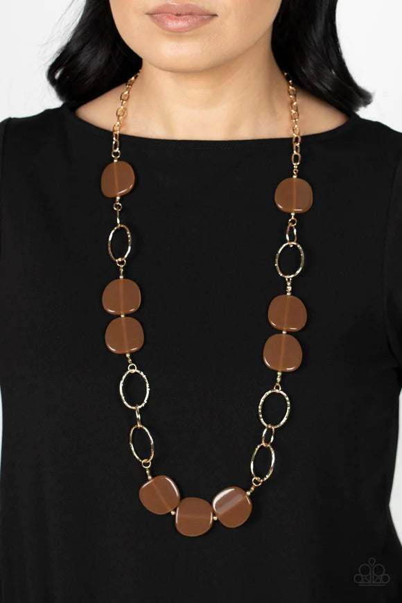 Paparazzi Accessories Posh Promenade - Browm An oversized collection of brown acrylic accents adorn sections of oversized textured gold links, resulting in a refined pop of color across the chest. Features an adjustable clasp closure. Sold as one individu